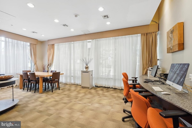 carpeted office with recessed lighting and visible vents