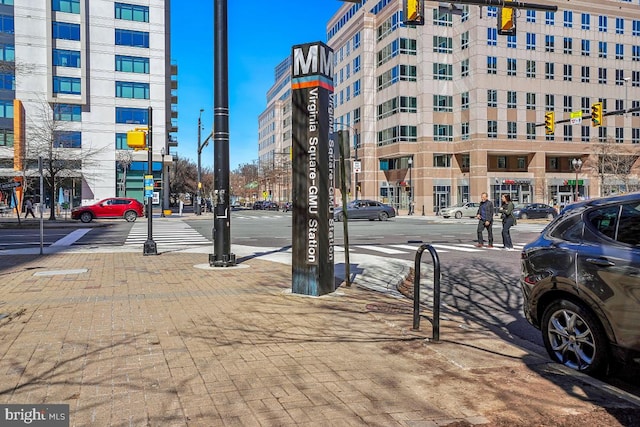 exterior space with sidewalks, street lights, and traffic lights