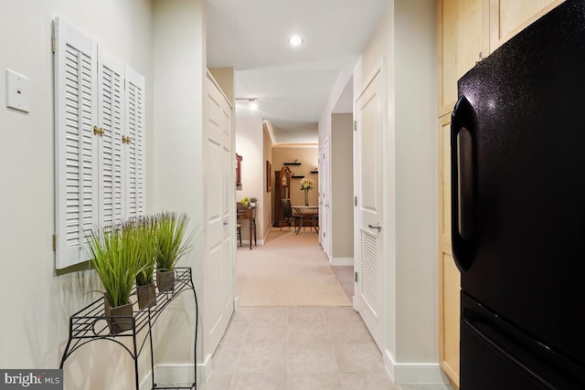 hall featuring recessed lighting, baseboards, and light tile patterned flooring