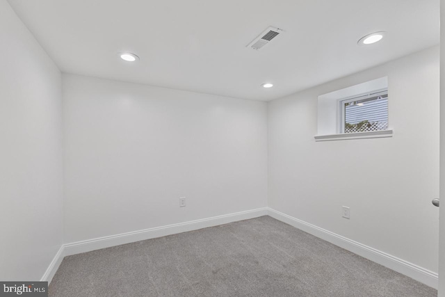 carpeted empty room with recessed lighting, visible vents, and baseboards