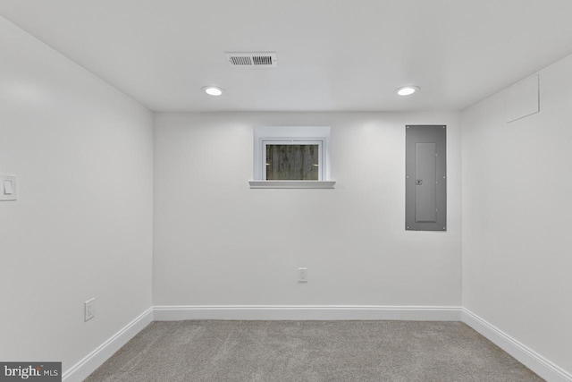 empty room featuring electric panel, visible vents, carpet flooring, and baseboards