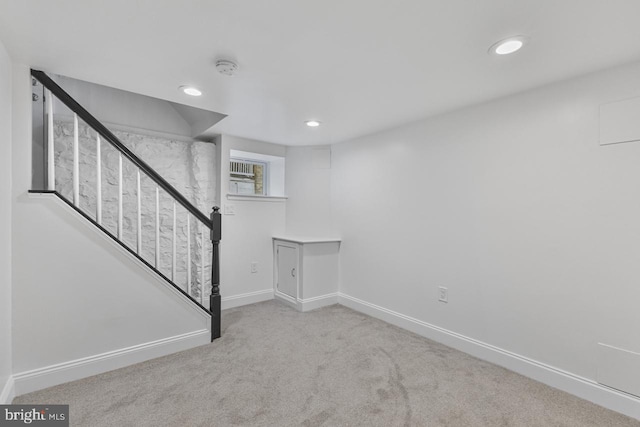 below grade area with recessed lighting, baseboards, carpet, and stairs