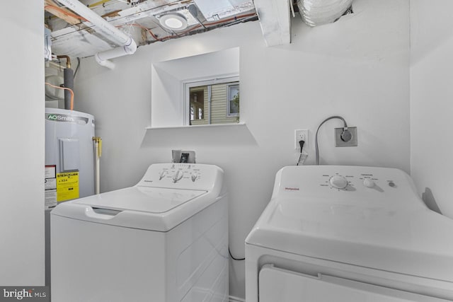 laundry area featuring laundry area, washing machine and dryer, and water heater