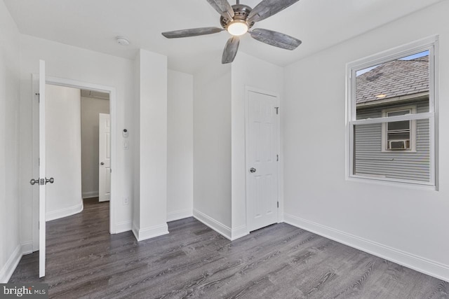 unfurnished bedroom with baseboards, ceiling fan, and dark wood-style flooring