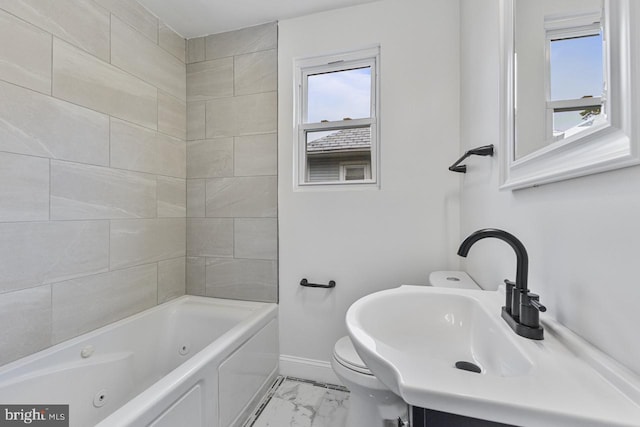 bathroom with vanity, toilet, baseboards, and marble finish floor