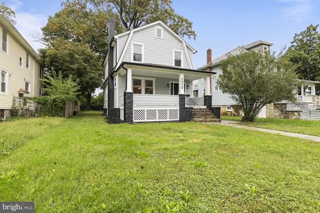 dutch colonial with a porch, a chimney, a gambrel roof, and a front lawn