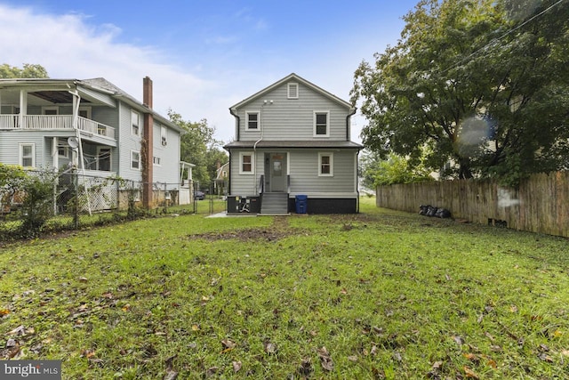 back of property featuring fence private yard and a yard