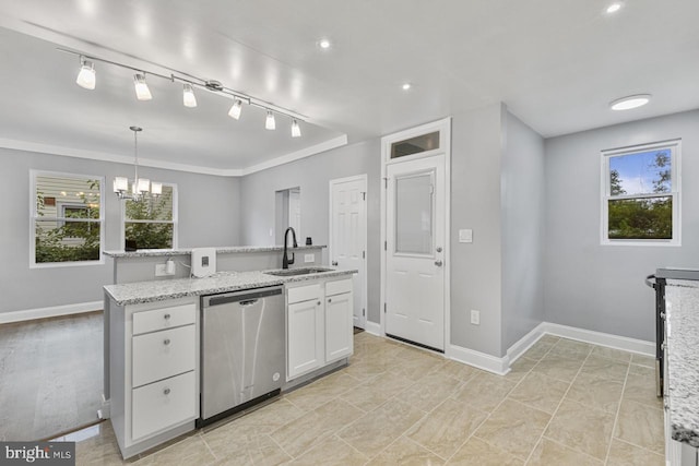 kitchen with baseboards, a center island with sink, white cabinetry, a sink, and stainless steel dishwasher