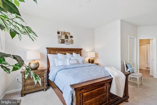 bedroom featuring light carpet and baseboards