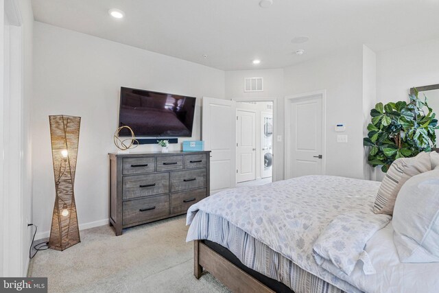 bedroom featuring light carpet, stacked washer / dryer, recessed lighting, and baseboards