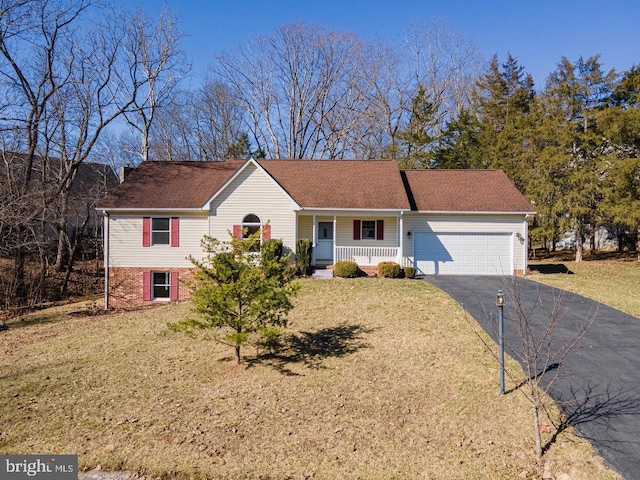 ranch-style home with a porch, an attached garage, a front yard, and aphalt driveway