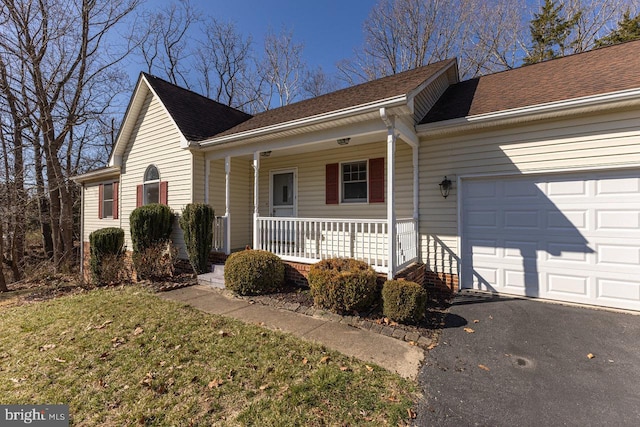 single story home featuring aphalt driveway, a garage, covered porch, and a shingled roof