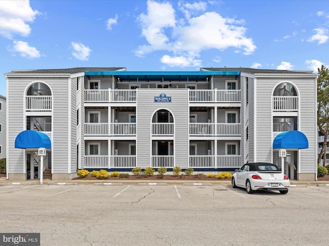 view of building exterior with uncovered parking