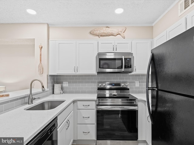 kitchen featuring white cabinetry, a sink, black appliances, and visible vents