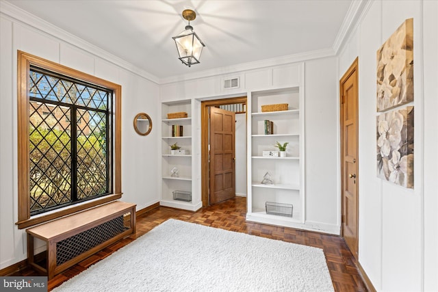 foyer featuring visible vents, baseboards, and crown molding