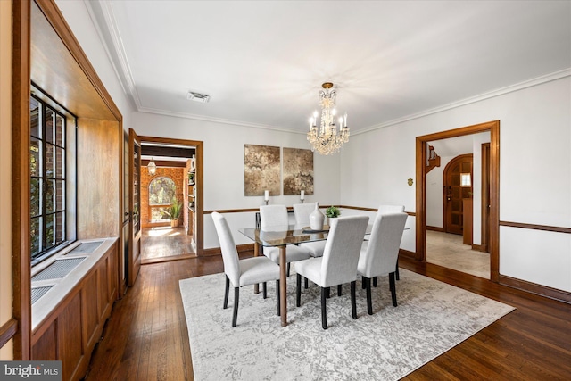 dining room with visible vents, a notable chandelier, ornamental molding, dark wood-style floors, and baseboards