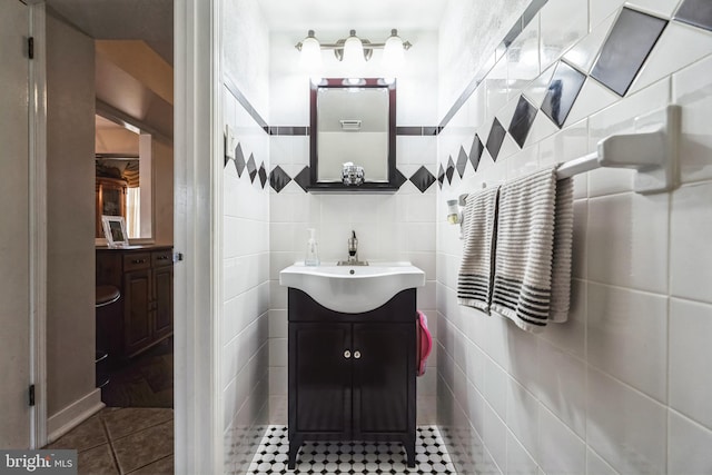 bathroom featuring vanity, tile patterned floors, and tile walls