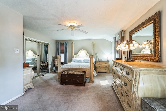 carpeted bedroom featuring a closet, lofted ceiling, a textured ceiling, and baseboards