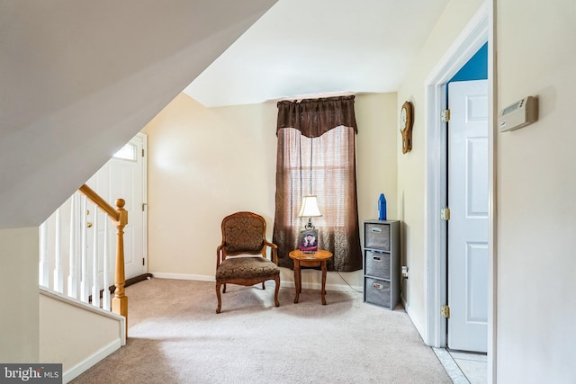 sitting room featuring carpet flooring, stairway, baseboards, and vaulted ceiling