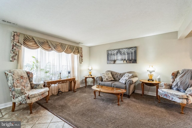 living area with light tile patterned flooring, baseboards, visible vents, and light carpet