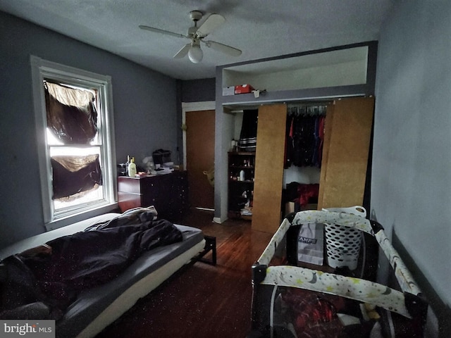 bedroom featuring a closet, a ceiling fan, and wood finished floors