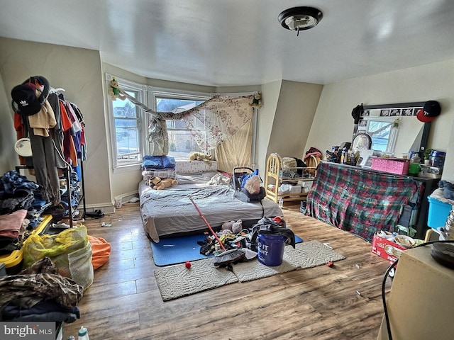 bedroom featuring baseboards and wood finished floors