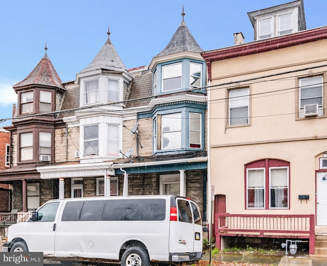 victorian-style house featuring a high end roof