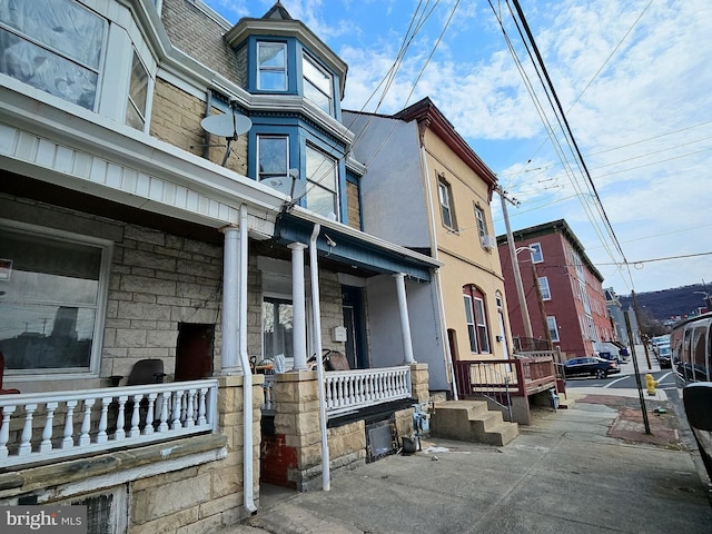 view of home's exterior featuring covered porch and stucco siding