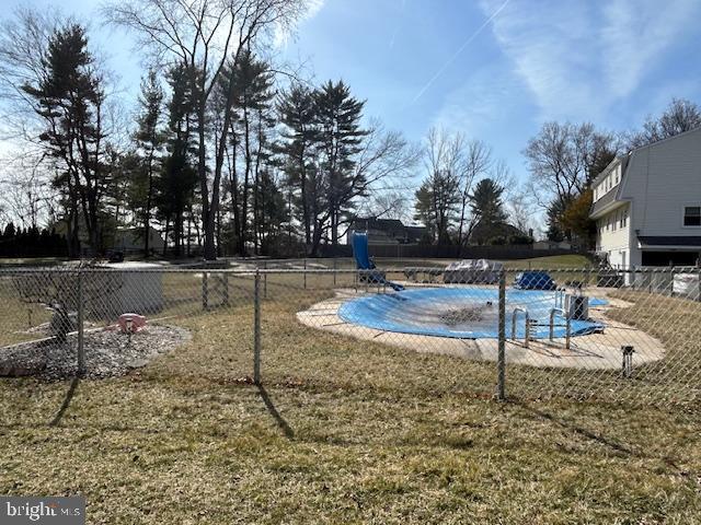 pool featuring fence and a lawn