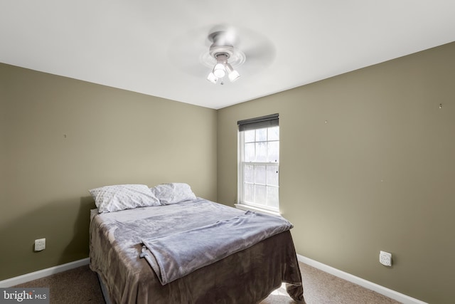 bedroom featuring baseboards, ceiling fan, and carpet flooring