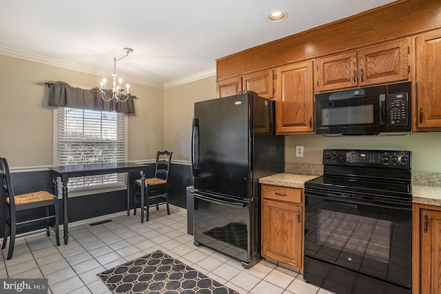 kitchen featuring visible vents, black appliances, ornamental molding, light countertops, and a chandelier