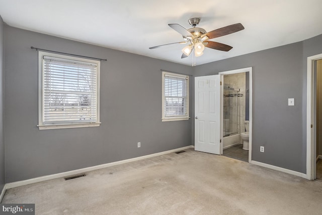 unfurnished bedroom with carpet, visible vents, ensuite bathroom, and baseboards