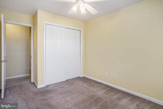 unfurnished bedroom featuring a closet, ceiling fan, baseboards, and carpet floors