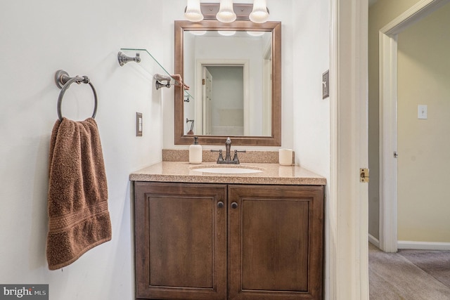 bathroom with baseboards and vanity