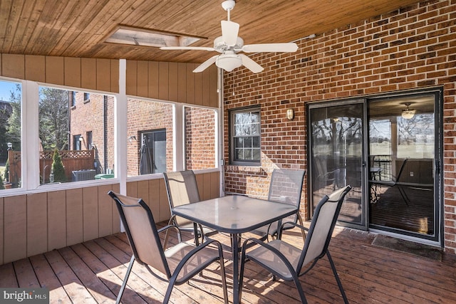 wooden deck featuring outdoor dining space and ceiling fan