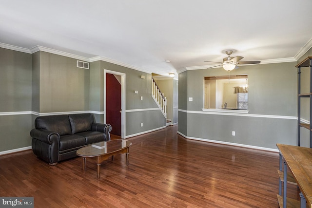 living room with stairway, a ceiling fan, wood finished floors, visible vents, and baseboards