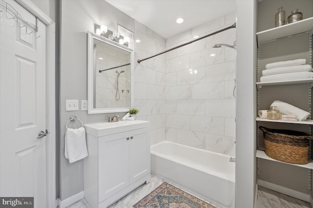 bathroom featuring baseboards, vanity, marble finish floor, and shower / bathtub combination