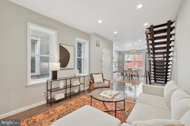 living room with visible vents, recessed lighting, baseboards, and wood finished floors