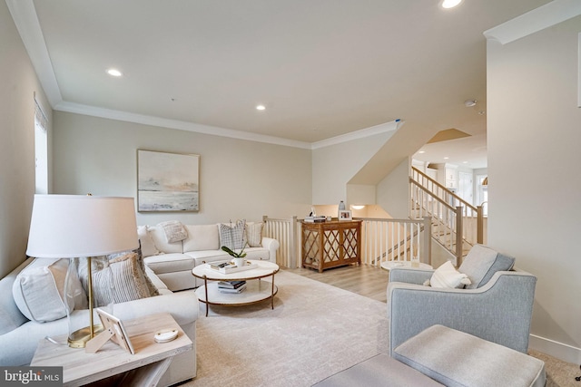 living area with recessed lighting, light wood-style floors, baseboards, and ornamental molding