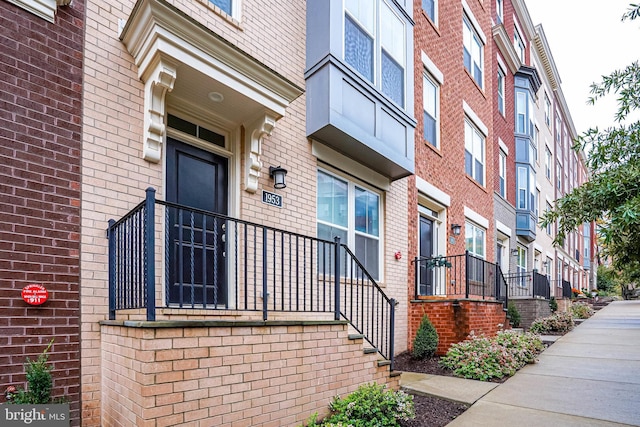 doorway to property with brick siding