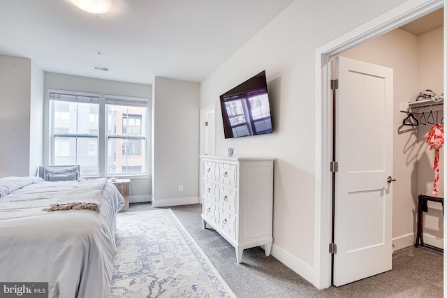 bedroom with carpet flooring, baseboards, and visible vents