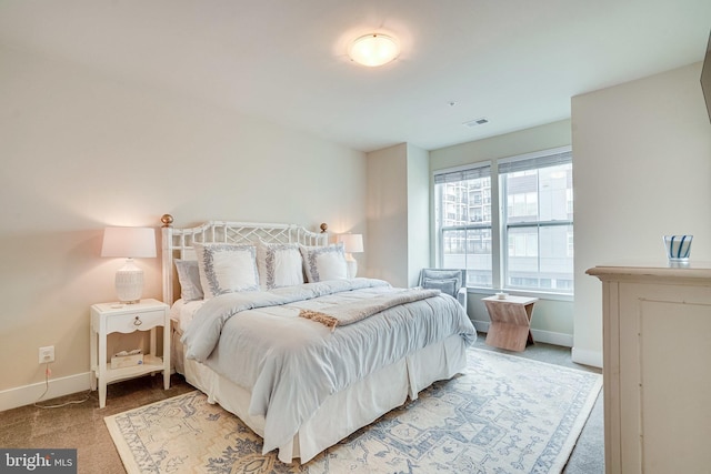 bedroom featuring visible vents, baseboards, and light colored carpet