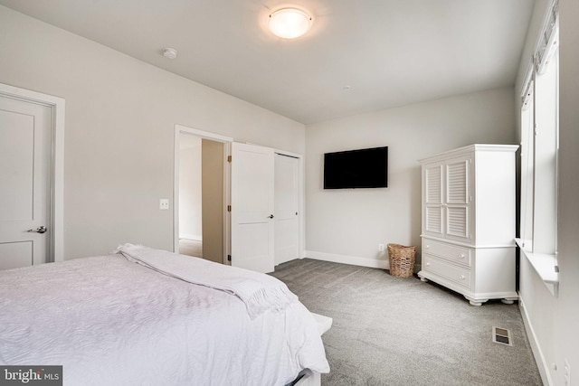 bedroom with visible vents, baseboards, a closet, and carpet flooring