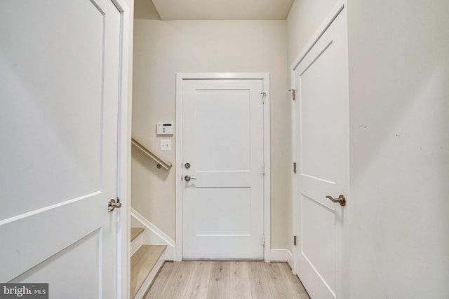 doorway to outside with stairway and light wood-type flooring