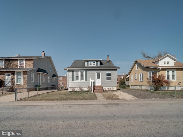 bungalow with a shingled roof, fence, entry steps, and a chimney