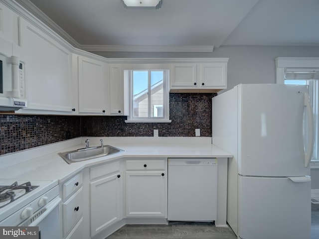 kitchen featuring backsplash, light wood-style floors, white appliances, white cabinetry, and a sink