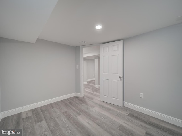 interior space featuring recessed lighting, baseboards, and wood finished floors