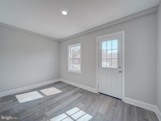 entryway with baseboards and wood finished floors