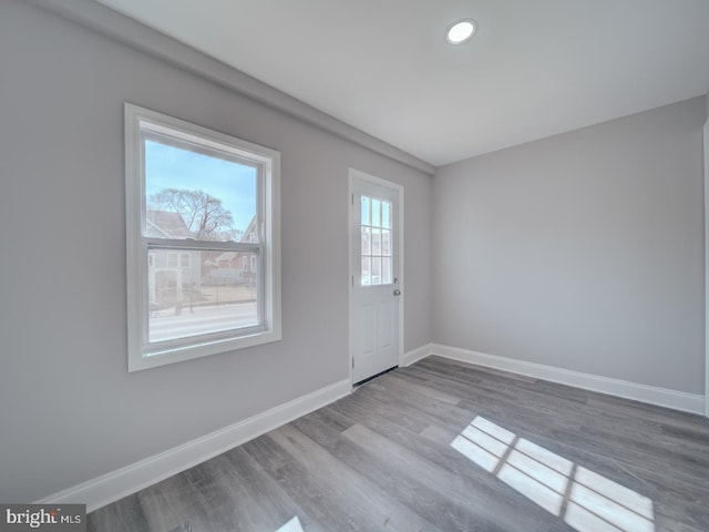 interior space featuring baseboards and wood finished floors