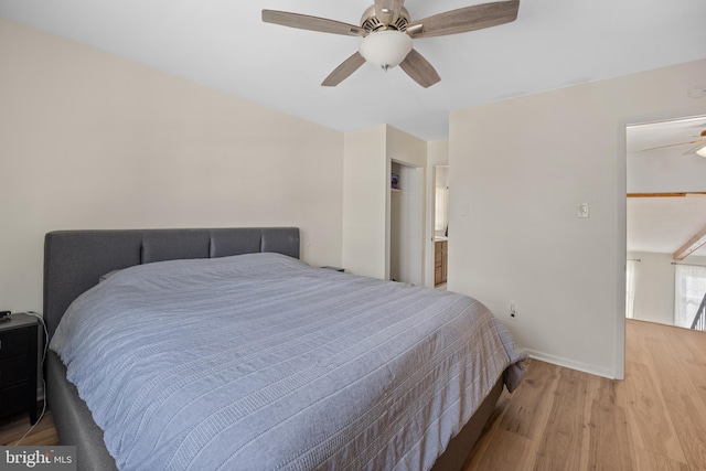 bedroom with a ceiling fan, baseboards, and wood finished floors